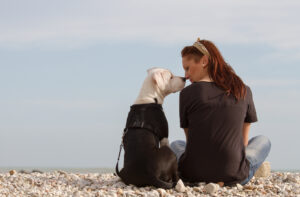 Image of a woman looking at her dog nose to nose